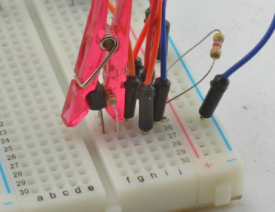 The resistor and the DS18B20 sensor are held together by a small clothespin